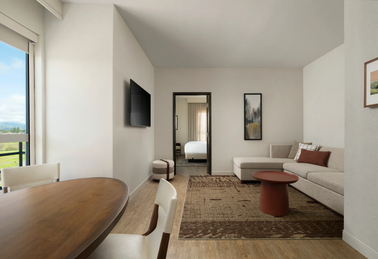 Living room and dining area in King Suite hotel room at The Knoll Hotel Napa Valley.