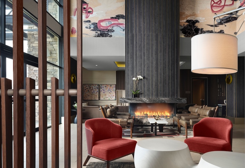 Entry and lobby area with indoor fireplace at The Knoll.